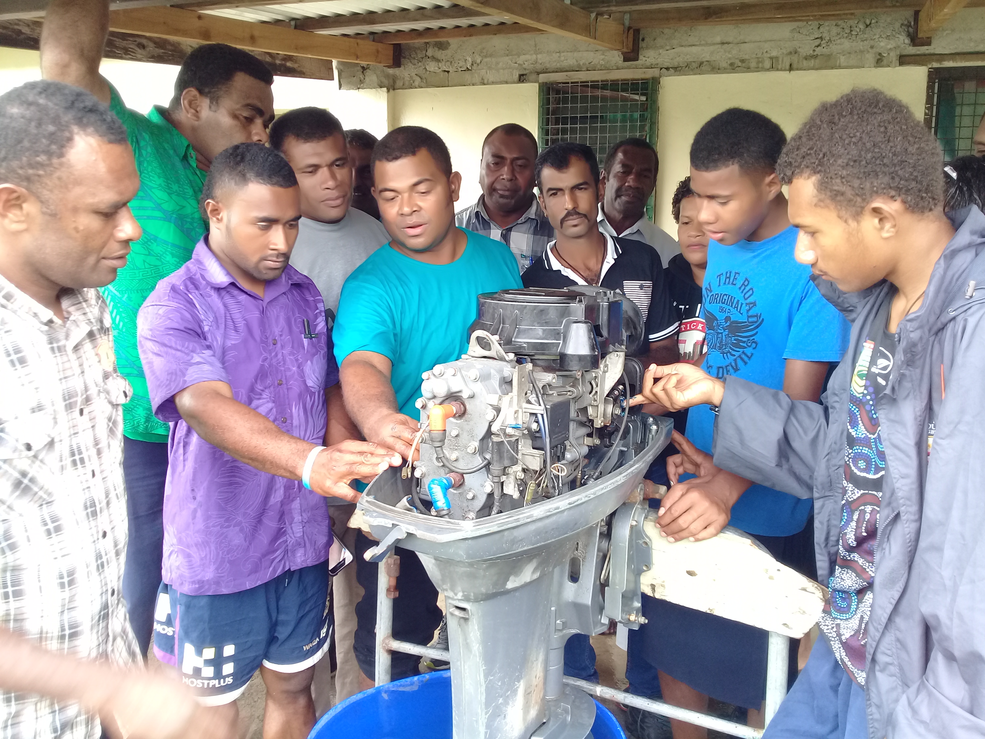 Mr Noa Gadekimerika (3rd from left) of MSAF explains the parts of an outboard engine to trainees at Narewa village in Ra